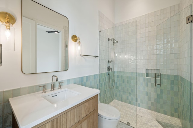724 Windsong Dr, Inlet Beach, FL 32461 - full bathroom with a shower stall, wainscoting, vanity, tile walls, and toilet