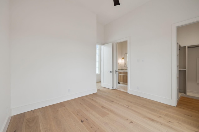 724 Windsong Dr, Inlet Beach, FL 32461 - unfurnished bedroom featuring ensuite bathroom, a walk in closet, light wood-style floors, ceiling fan, and baseboards