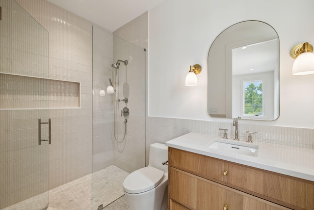 724 Windsong Dr, Inlet Beach, FL 32461 - bathroom with toilet, tile walls, wainscoting, a tile shower, and vanity