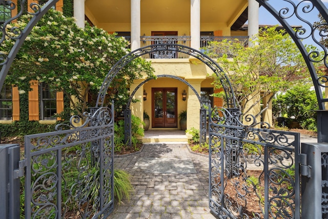 30 Place De La Fontaine, Miramar Beach, FL 32550 - entrance to property featuring stucco siding, a gate, a balcony, and french doors