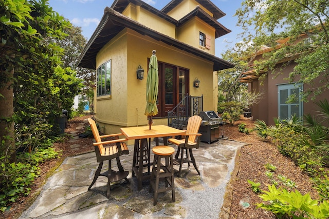 30 Place De La Fontaine, Miramar Beach, FL 32550 - view of patio featuring a grill and outdoor dining area