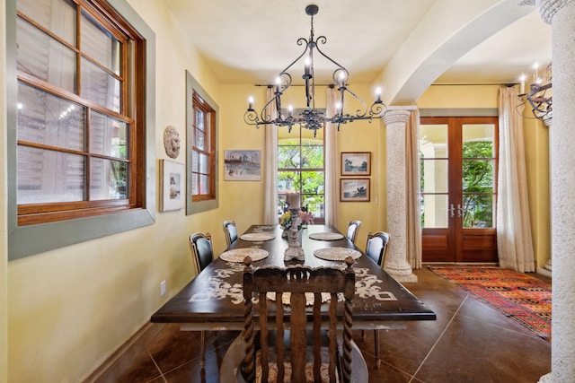 30 Place De La Fontaine, Miramar Beach, FL 32550 - dining room featuring a wealth of natural light, a chandelier, concrete floors, and arched walkways