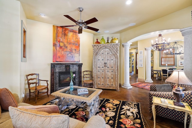 30 Place De La Fontaine, Miramar Beach, FL 32550 - living area featuring recessed lighting, a lit fireplace, ornate columns, arched walkways, and ceiling fan with notable chandelier