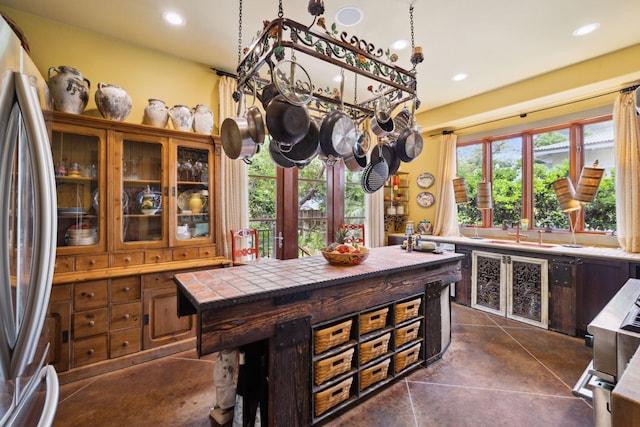 30 Place De La Fontaine, Miramar Beach, FL 32550 - kitchen featuring glass insert cabinets, recessed lighting, freestanding refrigerator, and a sink