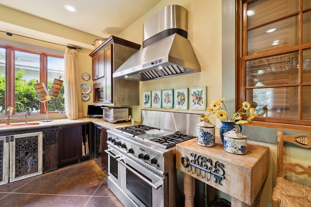30 Place De La Fontaine, Miramar Beach, FL 32550 - kitchen featuring a sink, light countertops, double oven range, dark tile patterned floors, and extractor fan