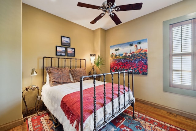 30 Place De La Fontaine, Miramar Beach, FL 32550 - bedroom featuring multiple windows, wood finished floors, a ceiling fan, and baseboards