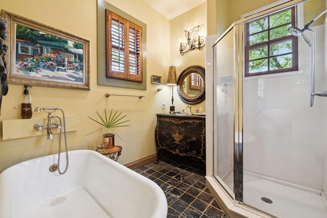 30 Place De La Fontaine, Miramar Beach, FL 32550 - bathroom featuring a freestanding tub, vanity, a stall shower, and baseboards