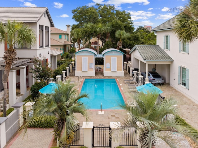 30 Place De La Fontaine, Miramar Beach, FL 32550 - community pool featuring an outdoor structure, a residential view, a storage unit, a patio area, and fence