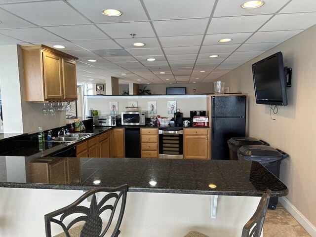 16819 Front Beach Rd Unit 1110, Panama City Beach, FL 32413 - kitchen with wine cooler, a sink, stainless steel microwave, a peninsula, and dark countertops