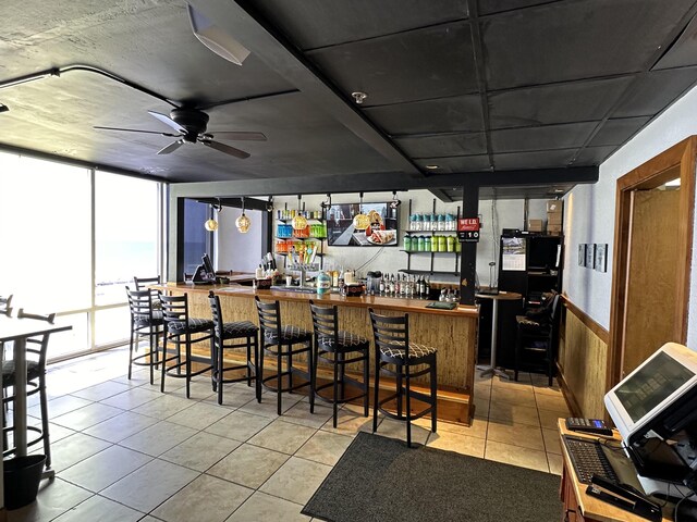 16819 Front Beach Rd Unit 1110, Panama City Beach, FL 32413 - bar featuring tile patterned floors, a dry bar, a wainscoted wall, and ceiling fan