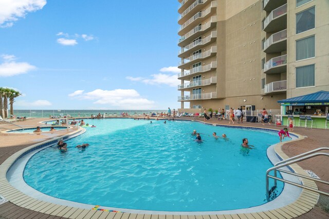 16819 Front Beach Rd Unit 1110, Panama City Beach, FL 32413 - community pool with fence, a water view, and a community hot tub