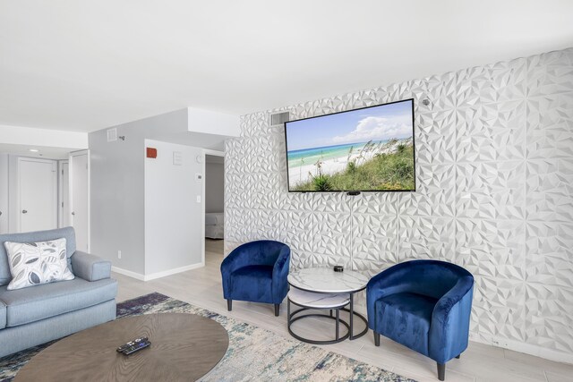 4260 Beachside Two Unit 4260, Miramar Beach, FL 32550 - living area with wood finished floors, an accent wall, wallpapered walls, and baseboards
