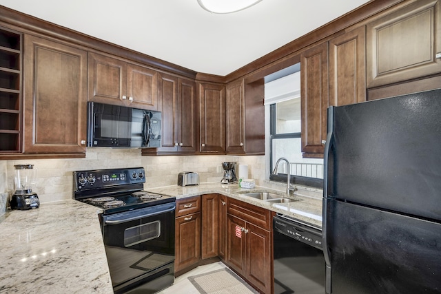 4260 Beachside Two Unit 4260, Miramar Beach, FL 32550 - kitchen with black appliances, a sink, light stone countertops, and tasteful backsplash