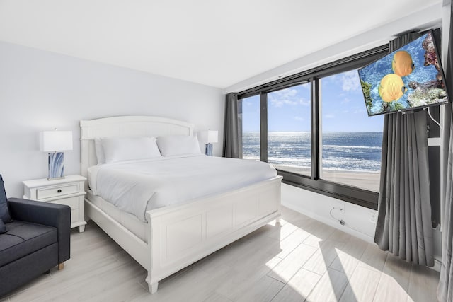 4260 Beachside Two Unit 4260, Miramar Beach, FL 32550 - bedroom featuring a water view and light wood-type flooring