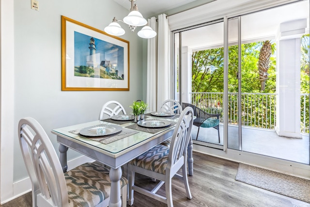 9200 Baytowne Wharf Blvd Unit 441, Miramar Beach, FL 32550 - dining area featuring wood finished floors, a chandelier, and healthy amount of natural light