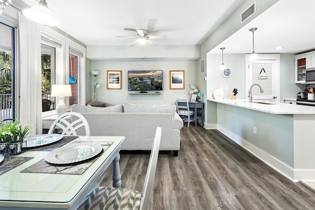 9200 Baytowne Wharf Blvd Unit 441, Miramar Beach, FL 32550 - dining room with dark wood-style floors, a ceiling fan, and baseboards