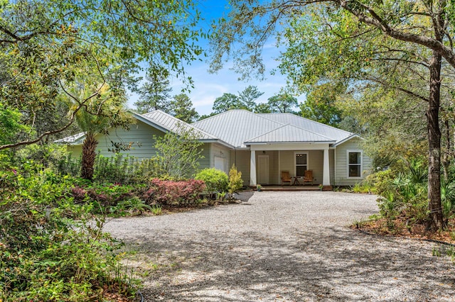 135 Bayou Point Dr, Santa Rosa Beach, FL 32459 - single story home featuring a porch, driveway, a garage, and metal roof