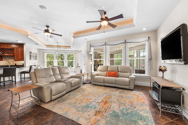 135 Bayou Point Dr, Santa Rosa Beach, FL 32459 - living room featuring ceiling fan, baseboards, and a raised ceiling