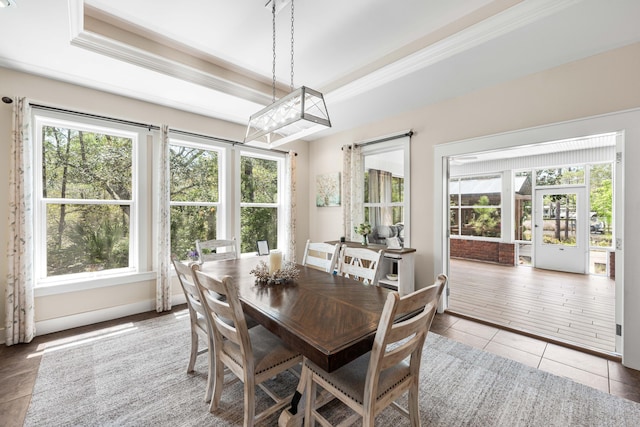 135 Bayou Point Dr, Santa Rosa Beach, FL 32459 - dining room with a tray ceiling, tile patterned flooring, and crown molding