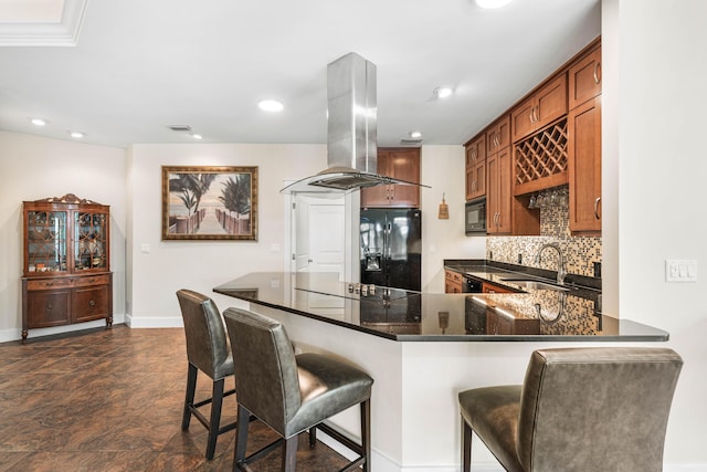 135 Bayou Point Dr, Santa Rosa Beach, FL 32459 - kitchen featuring a sink, island range hood, decorative backsplash, black appliances, and a breakfast bar area