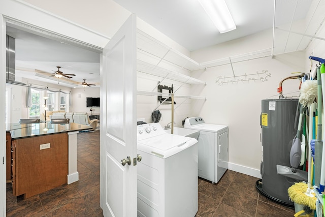 135 Bayou Point Dr, Santa Rosa Beach, FL 32459 - washroom featuring washing machine and dryer, water heater, stone finish flooring, ceiling fan, and laundry area