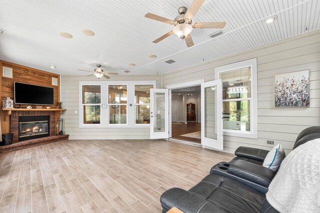 135 Bayou Point Dr, Santa Rosa Beach, FL 32459 - living room with wood finished floors, wood walls, ceiling fan, and french doors