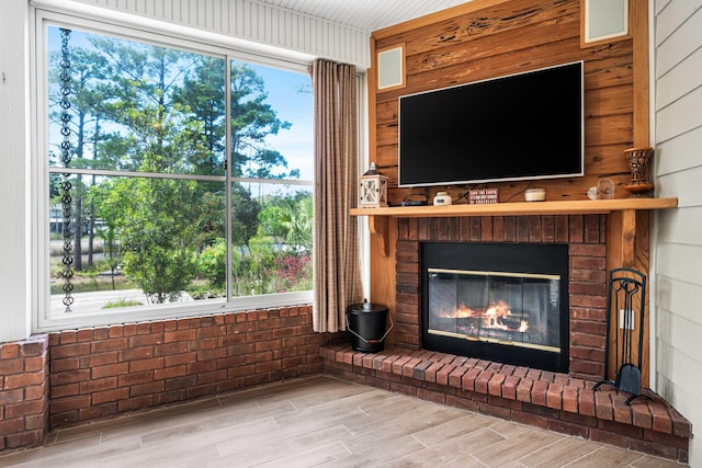 135 Bayou Point Dr, Santa Rosa Beach, FL 32459 - unfurnished living room with wood walls, wood finished floors, and a fireplace