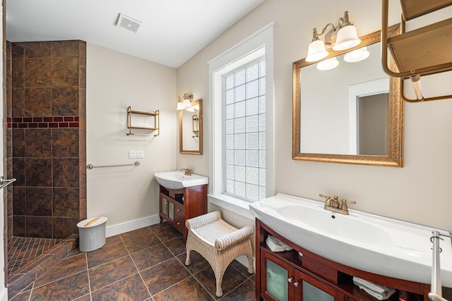135 Bayou Point Dr, Santa Rosa Beach, FL 32459 - full bath featuring two vanities, a sink, tiled shower, visible vents, and baseboards