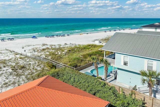 birds eye view of property with a beach view and a water view