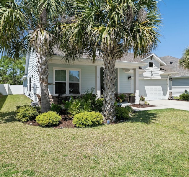 view of front facade featuring a front lawn, stone siding, concrete driveway, fence, and a garage