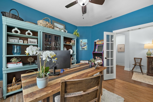 office with french doors, baseboards, visible vents, wood finished floors, and ceiling fan