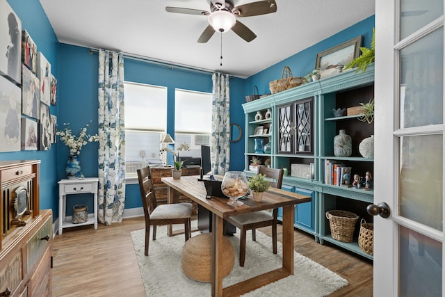 dining room featuring a ceiling fan and wood finished floors