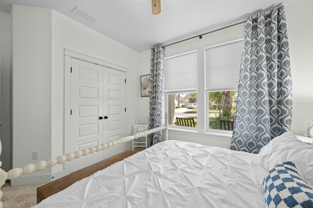 bedroom featuring a closet, visible vents, and ceiling fan
