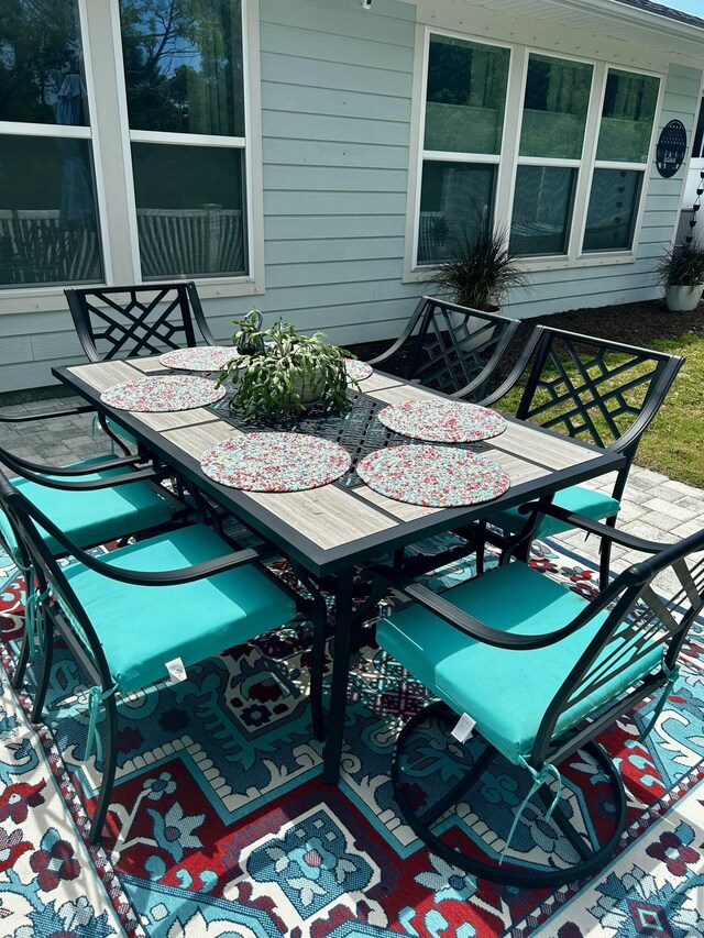 wooden deck featuring a patio and outdoor dining area