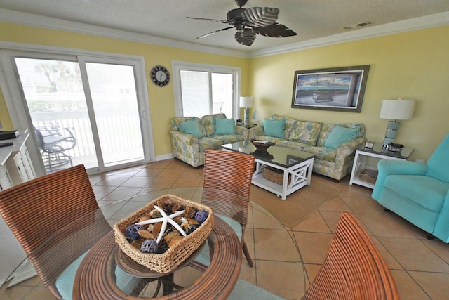 tiled living area featuring crown molding, a textured ceiling, visible vents, and ceiling fan