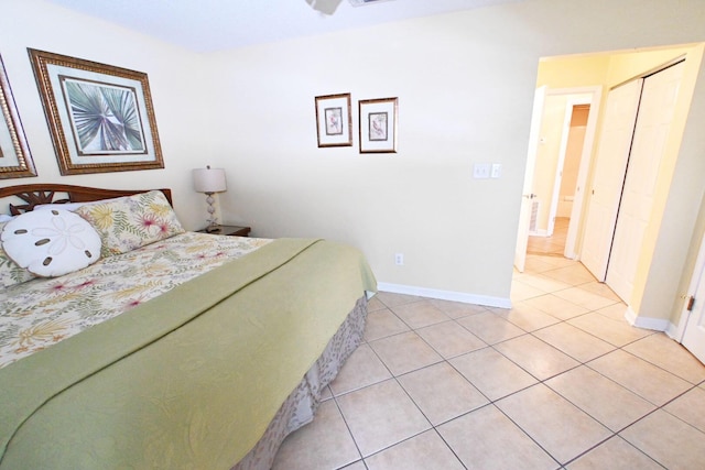 bedroom featuring light tile patterned floors, a closet, visible vents, and baseboards