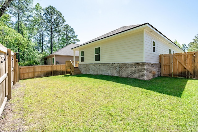 142 N Marsh Lndg, Freeport, FL 32439 - rear view of property featuring a lawn, brick siding, and a fenced backyard