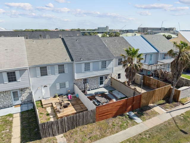356 Billfish Ave Unit 4, Fort Walton Beach, FL 32548 - rear view of house featuring a fenced backyard, stone siding, a residential view, and a deck