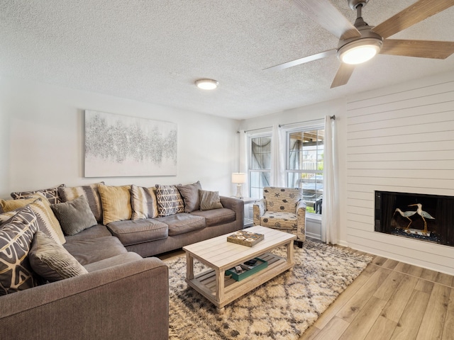 356 Billfish Ave Unit 4, Fort Walton Beach, FL 32548 - living area featuring a ceiling fan, wood finished floors, a textured ceiling, and a fireplace