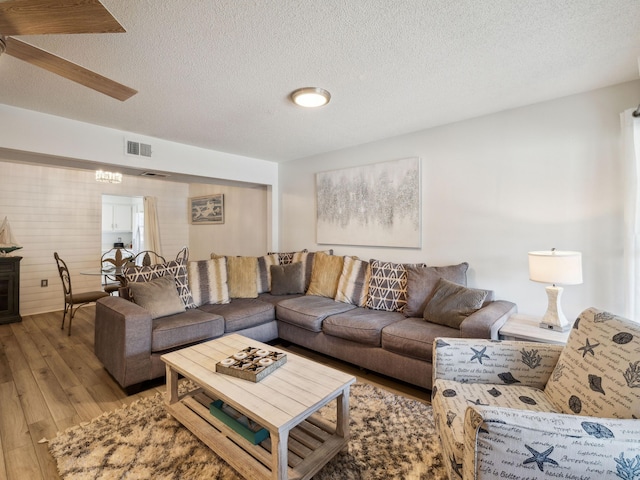 356 Billfish Ave Unit 4, Fort Walton Beach, FL 32548 - living room featuring a textured ceiling, light wood-type flooring, visible vents, and a ceiling fan