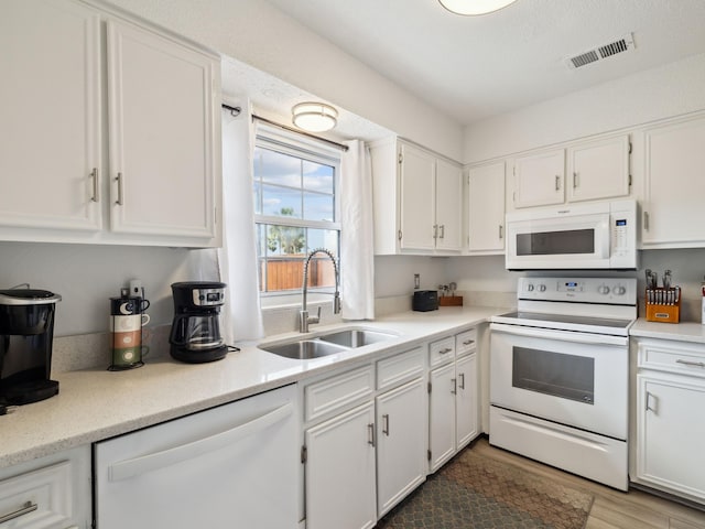 356 Billfish Ave Unit 4, Fort Walton Beach, FL 32548 - kitchen with wood finished floors, a sink, white appliances, white cabinets, and visible vents
