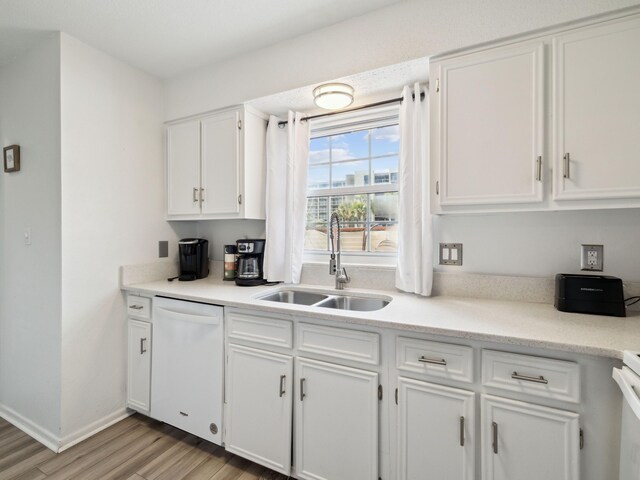 356 Billfish Ave Unit 4, Fort Walton Beach, FL 32548 - kitchen with white cabinets, light wood-style flooring, a sink, white dishwasher, and light countertops