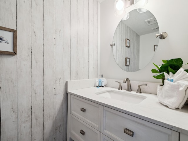 356 Billfish Ave Unit 4, Fort Walton Beach, FL 32548 - bathroom with visible vents, wooden walls, and vanity