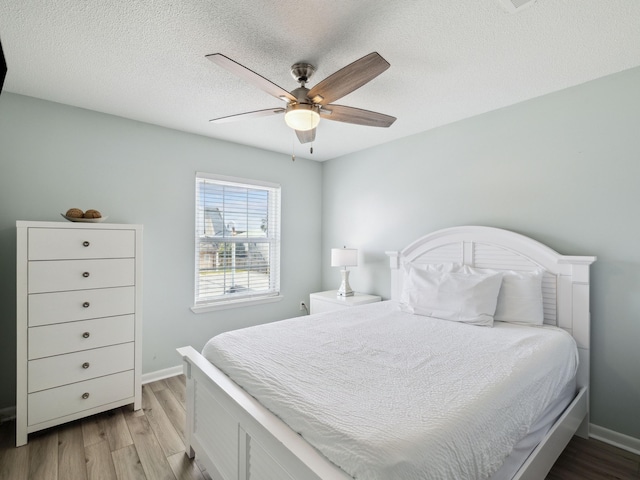 356 Billfish Ave Unit 4, Fort Walton Beach, FL 32548 - bedroom with light wood finished floors, baseboards, a textured ceiling, and ceiling fan