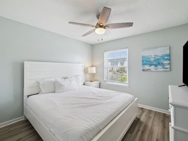 356 Billfish Ave Unit 4, Fort Walton Beach, FL 32548 - bedroom featuring baseboards, a ceiling fan, wood finished floors, and a textured ceiling