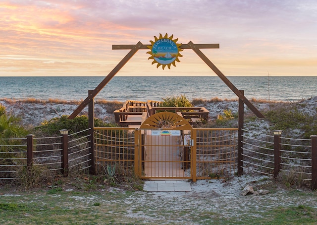 property view of water featuring a gate and fence