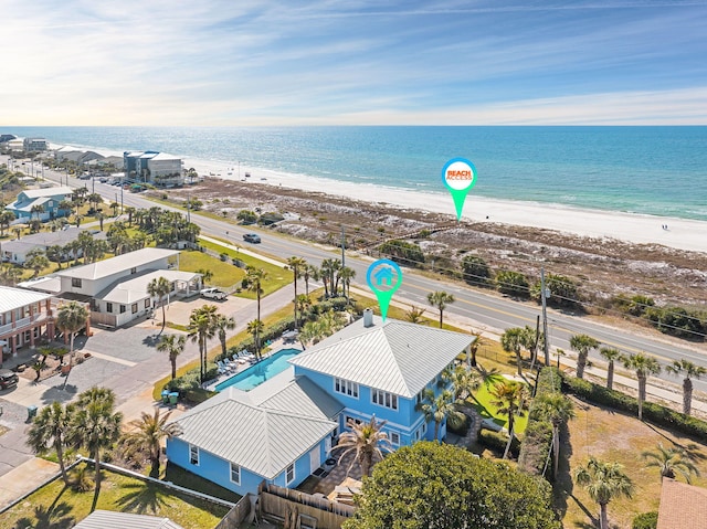 drone / aerial view with a beach view and a water view