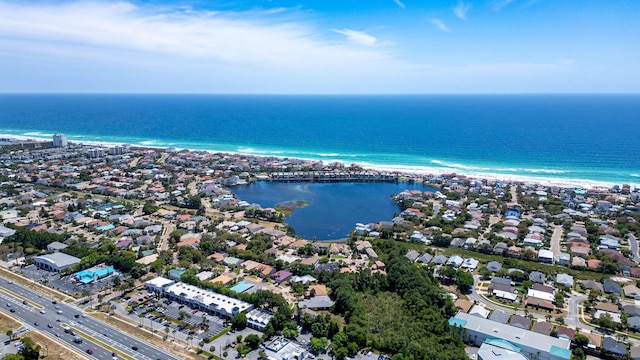 drone / aerial view featuring a beach view and a water view