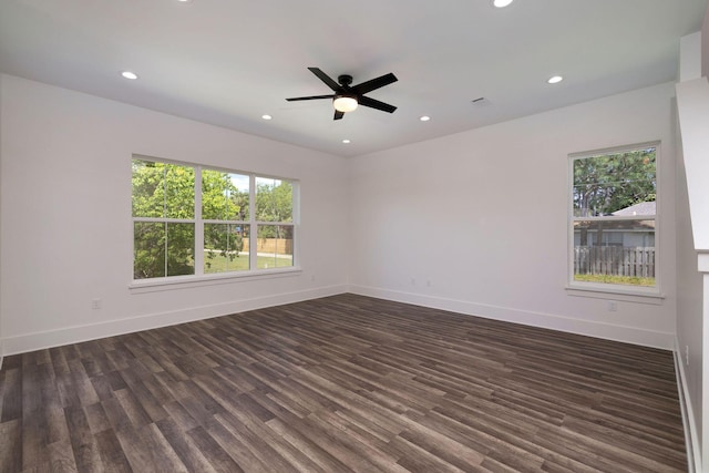 unfurnished room with recessed lighting, baseboards, a wealth of natural light, and dark wood-type flooring