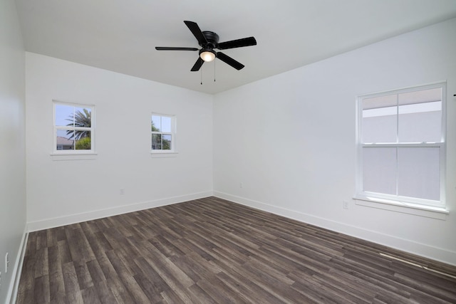 unfurnished room featuring baseboards, ceiling fan, and dark wood-style flooring